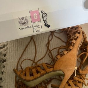 Cape Robin brown knee high strap heels.